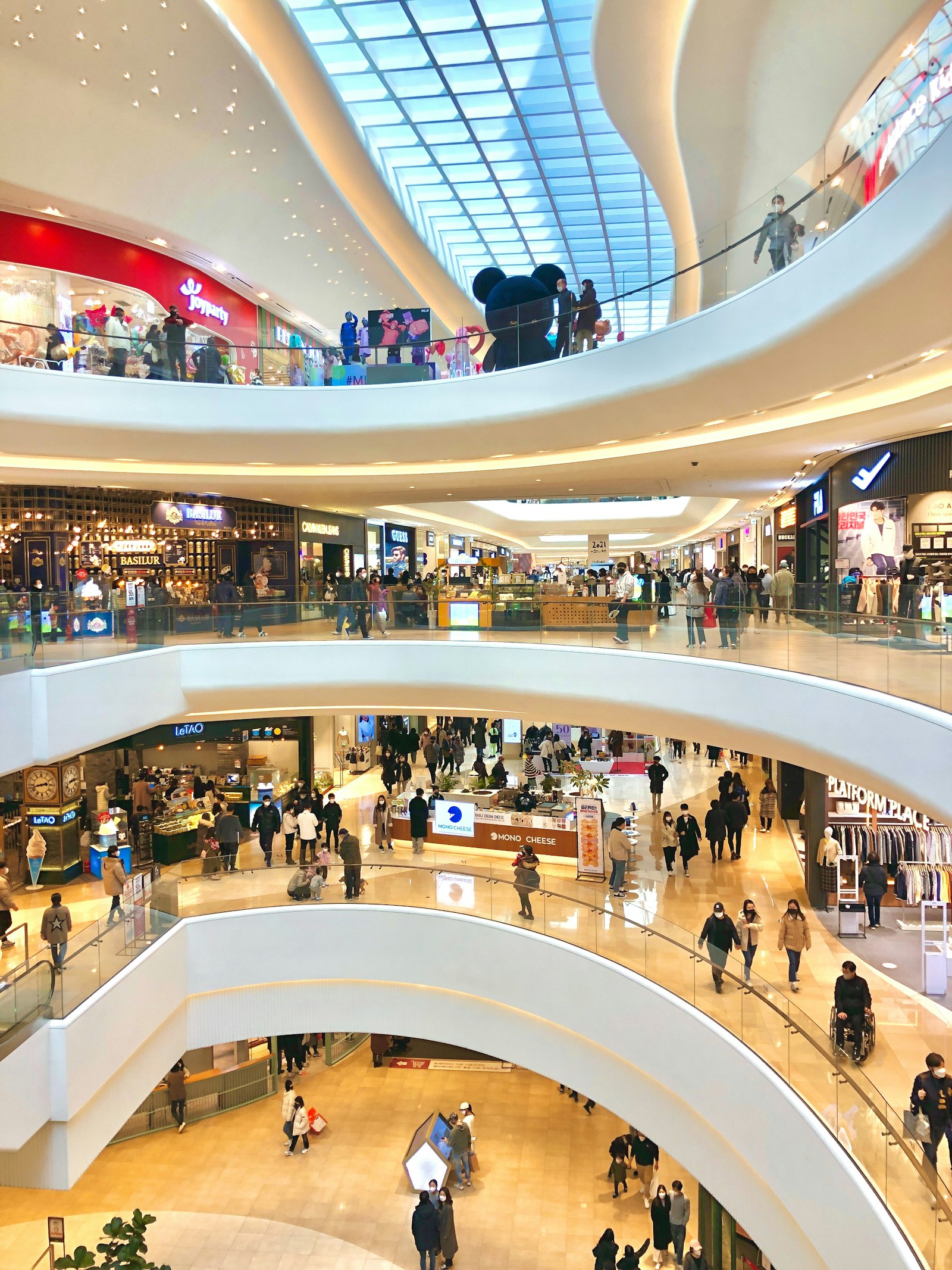 Multidão de consumidores circula por corredor de shopping center em dia de promoção