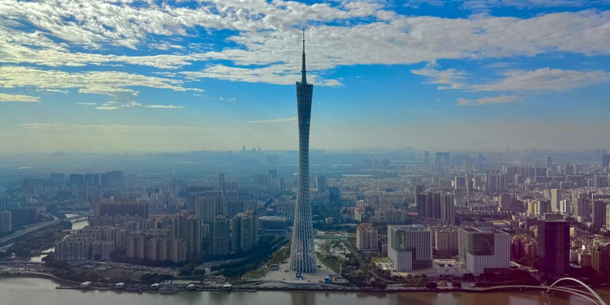 Canton Tower se ergue sobre a paisagem urbana de Guangzhou, na China, às margens de um rio